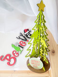 DYI unpainted Grinch themed tree & Believe sign